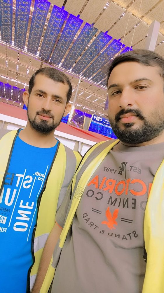 Two Al Khidmat Fixers technicians in high-visibility vests on site